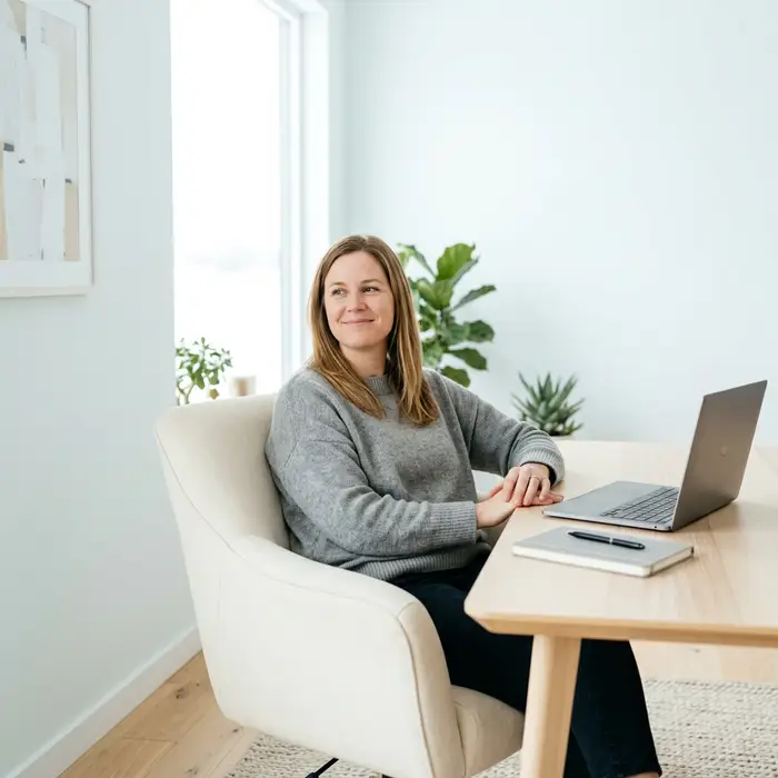 Founder leaning back at desk, visibly relaxed