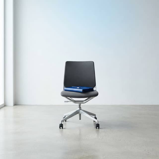 Minimalist designer chair with a blue folder