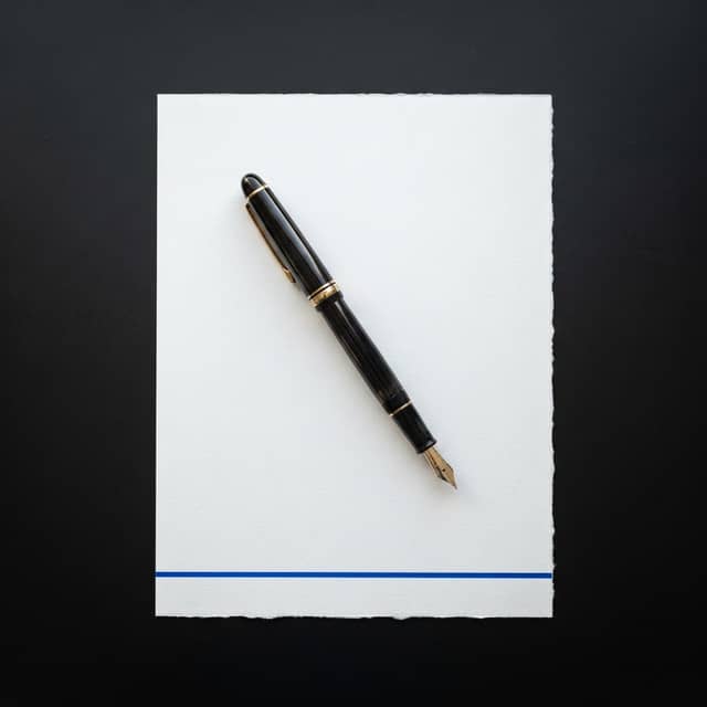 Fountain pen on a document with blue accent