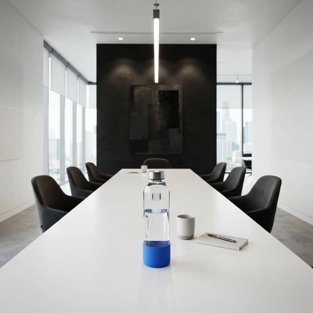 Modern minimalist meeting room with a single blue-accented bottle