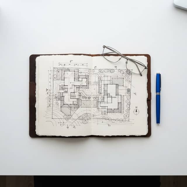 A high-level architectural site map on a clean desk