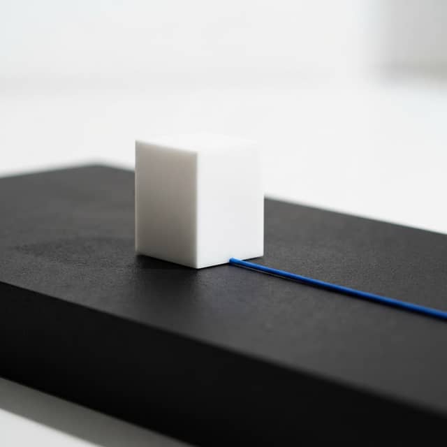 Clean white structural block with a single electric blue accent line