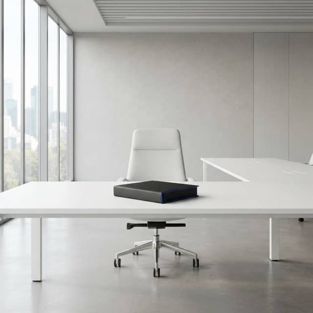 A single chair and binder in a minimalist boardroom