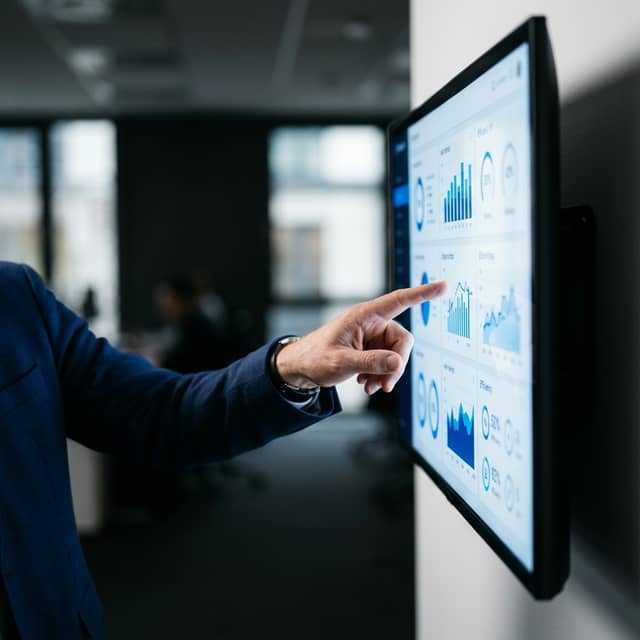 Hand pointing to workflow efficiency dashboard metrics