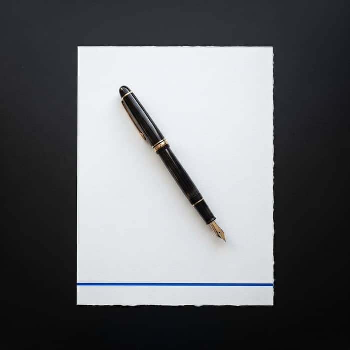 Fountain pen on a document with blue accent
