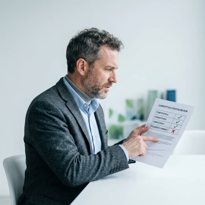 Founder reviewing AI citation visibility audit results